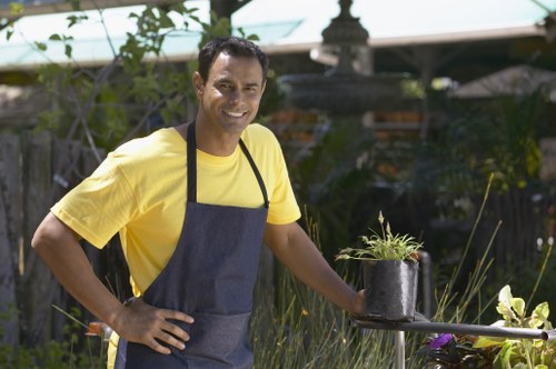 Gardener with safety gear inspecting a residential garden