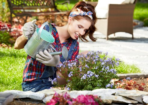 Gardener assessing a Wood Green front garden for pricing