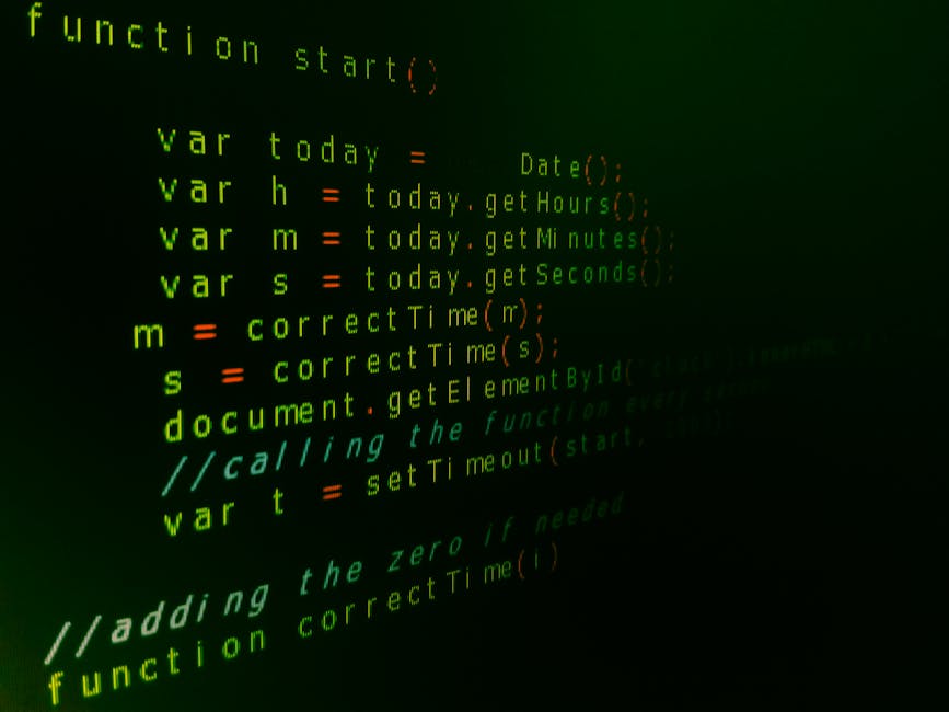 A photograph of computer code displayed on a dark screen featuring green, white, red, and yellow syntax. The code appears to be written in JavaScript, with functions, variables, and comments visible,